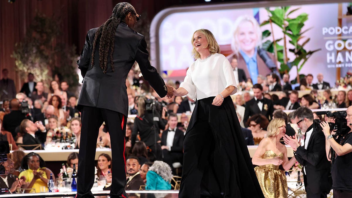 Snoop Dogg greets Amy Poehler on stage at Golden Globes