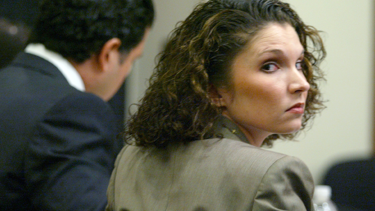 Melanie McGuire looks back during a court proceeding related to the death of her husband, Bill McGuire