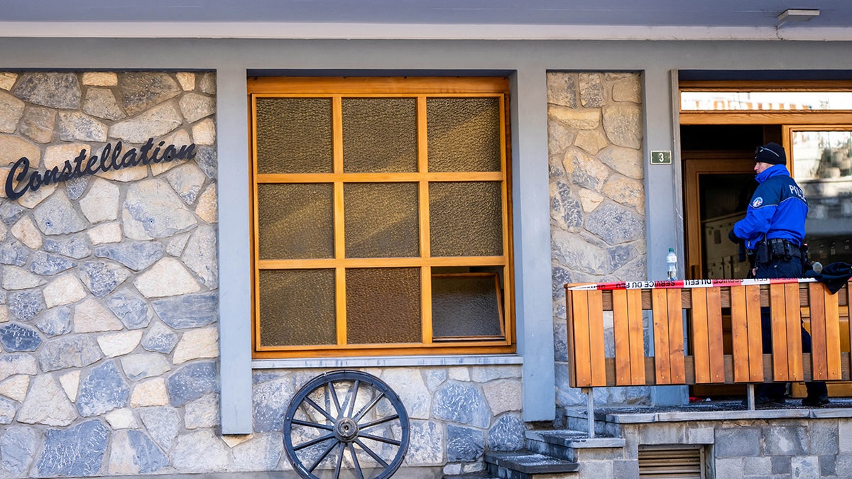 Police officer stands at scene of bar fire in Switzerland