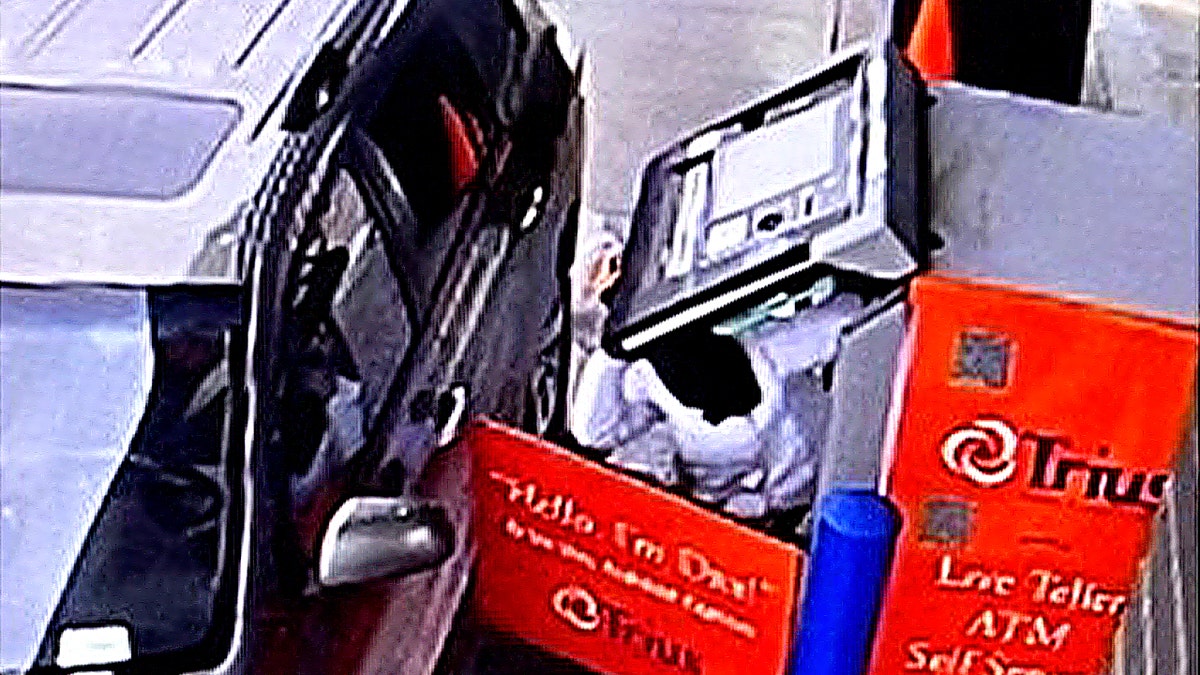 ATM with open panel and exposed components