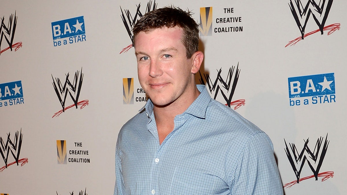 WWE star Ted DiBiase poses at a VIP party inside a hotel.