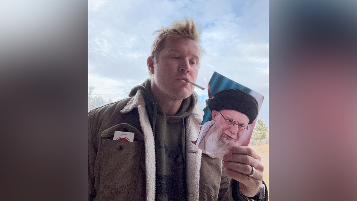 Sen. Tim Sheehy, R-Mont., lights a cigarette on a burning photo of Khamenei