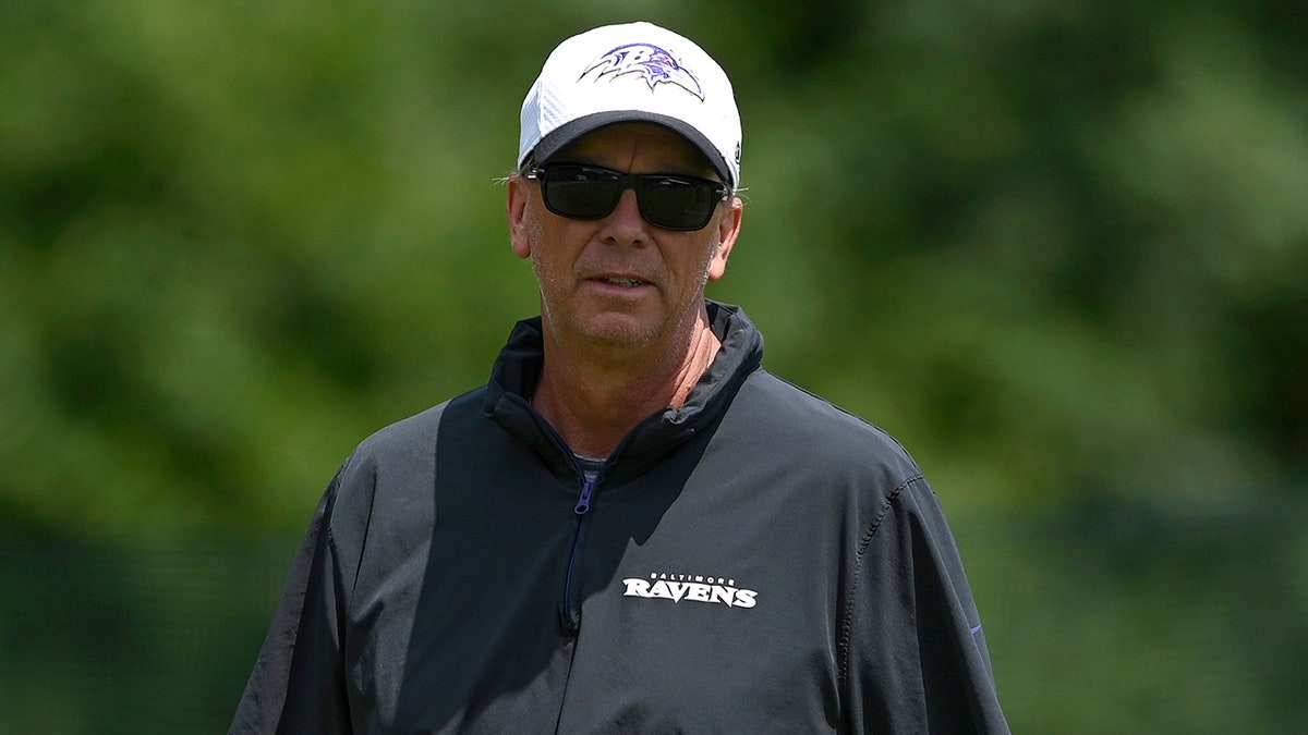 Todd Monken walks field