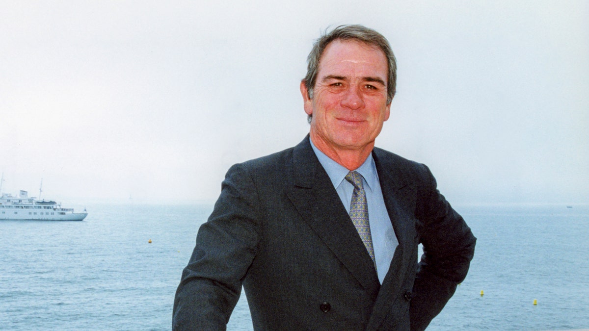 Tommy Lee Jones stands in front of the ocean view