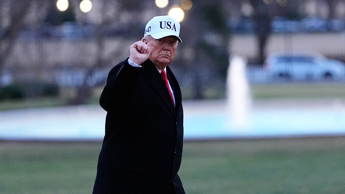 President Donald Trump gestures as he walks from Marine One after arriving on the South Lawn of the White House, Tuesday, Jan. 13, 2026, in Washington. (AP Photo/Alex Brandon)