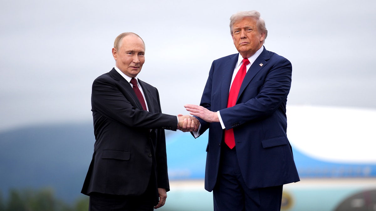Trump and Putin shake hands 