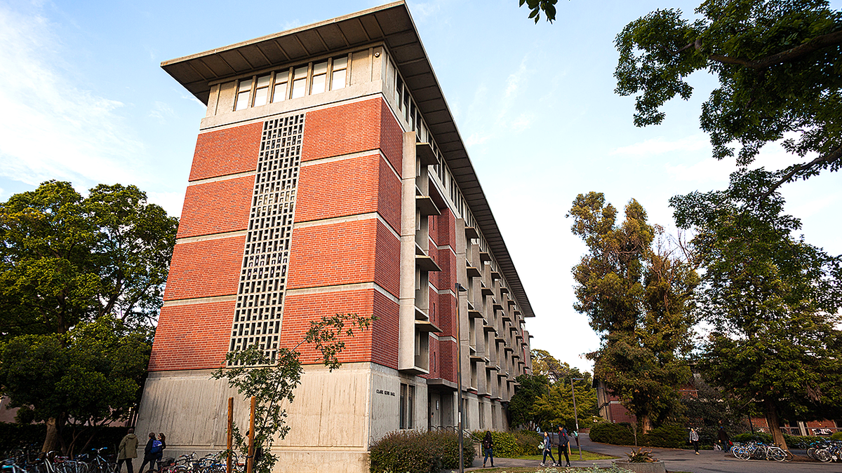 UC Davis Kerr Hall exterior with students walking by.
