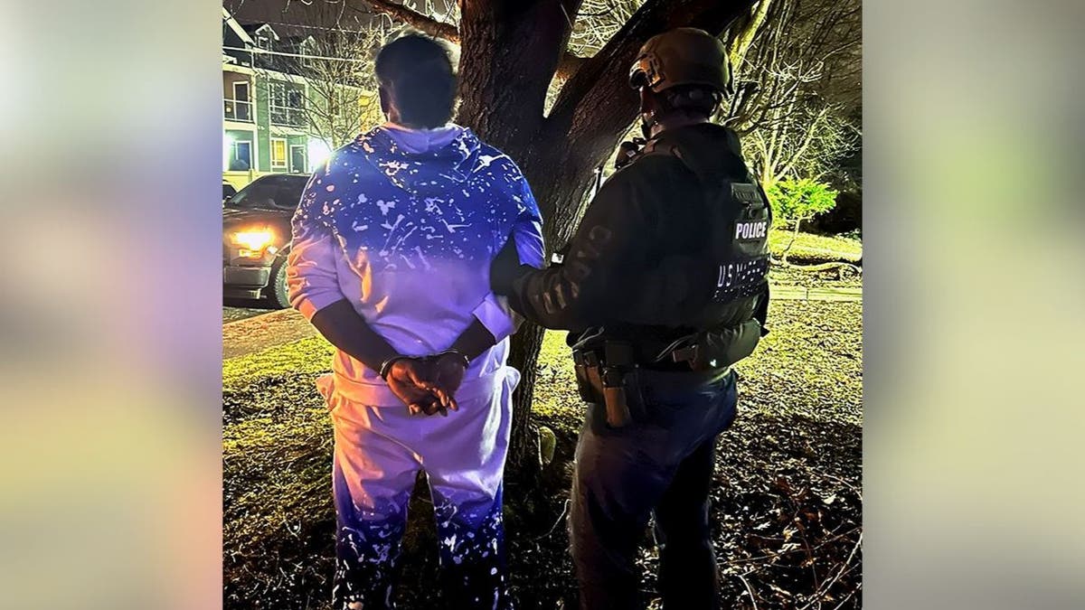 U.S. Marshals arrest a suspect during a nighttime operation in Spokane, Washington.