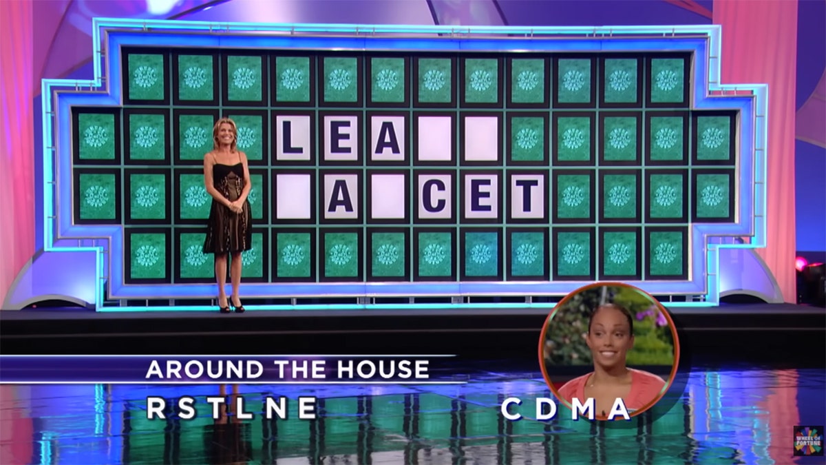 "Wheel of Fortune" puzzle board displays partially revealed letters during a game show round.