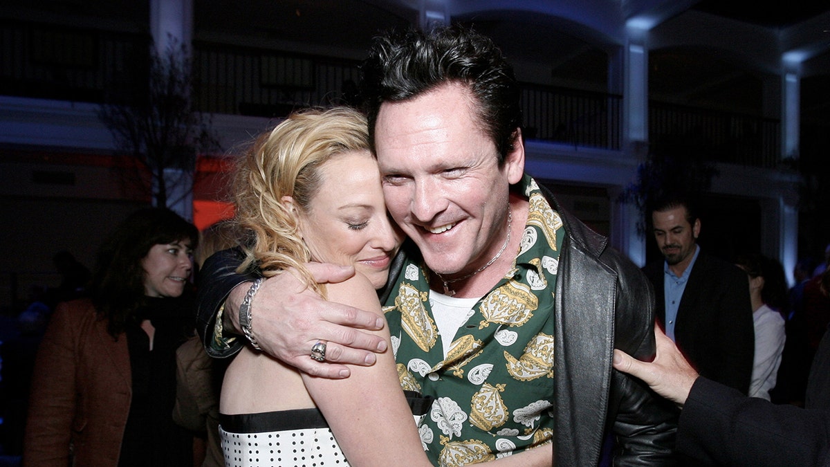 Michael Madsen smiling and embracing his sister Virginia Madsen.