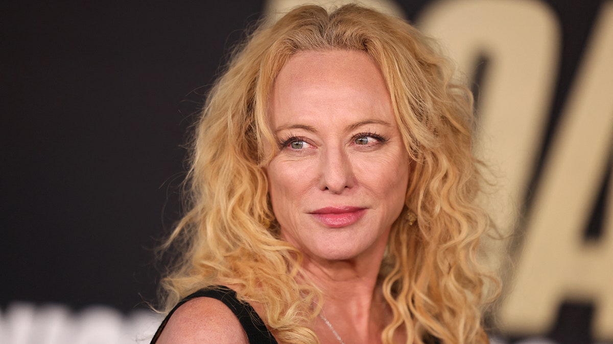 A close-up of Virginia Madsen wearing a black strappy dress.