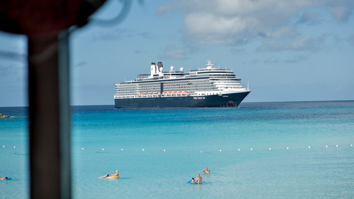 A Holland America Line ship sails close to the sea