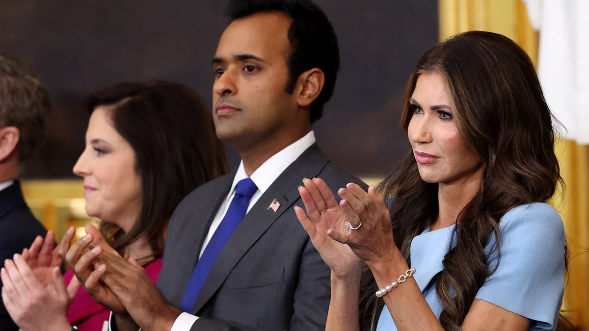 Vivek Ramaswamy and Kristi Noem clap during President Donald Trump's inauguration