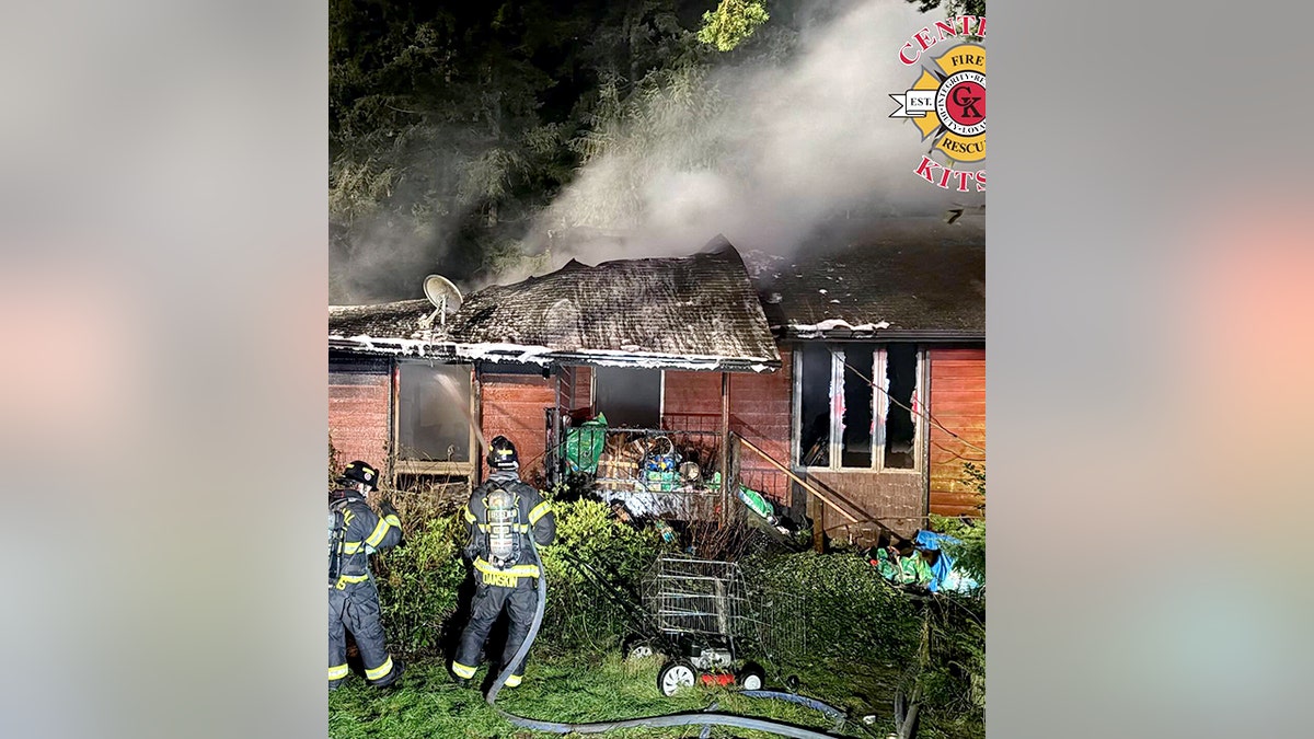 firefighters outside burning home