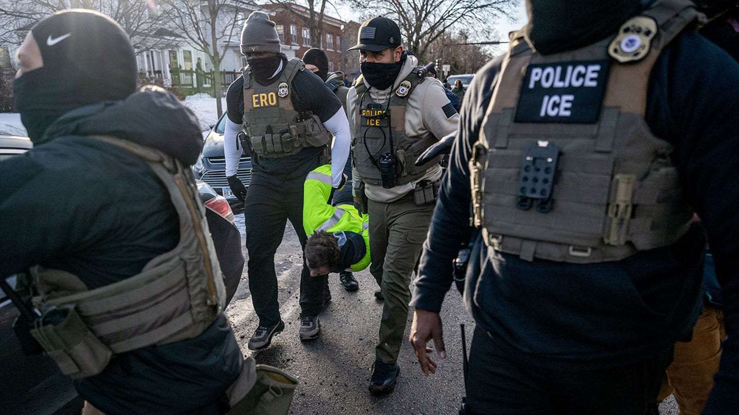 Federal law enforcement agents detain a demonstrator during a raid in south Minneapolis. (Victor J. Blue/Bloomberg via Getty Images)