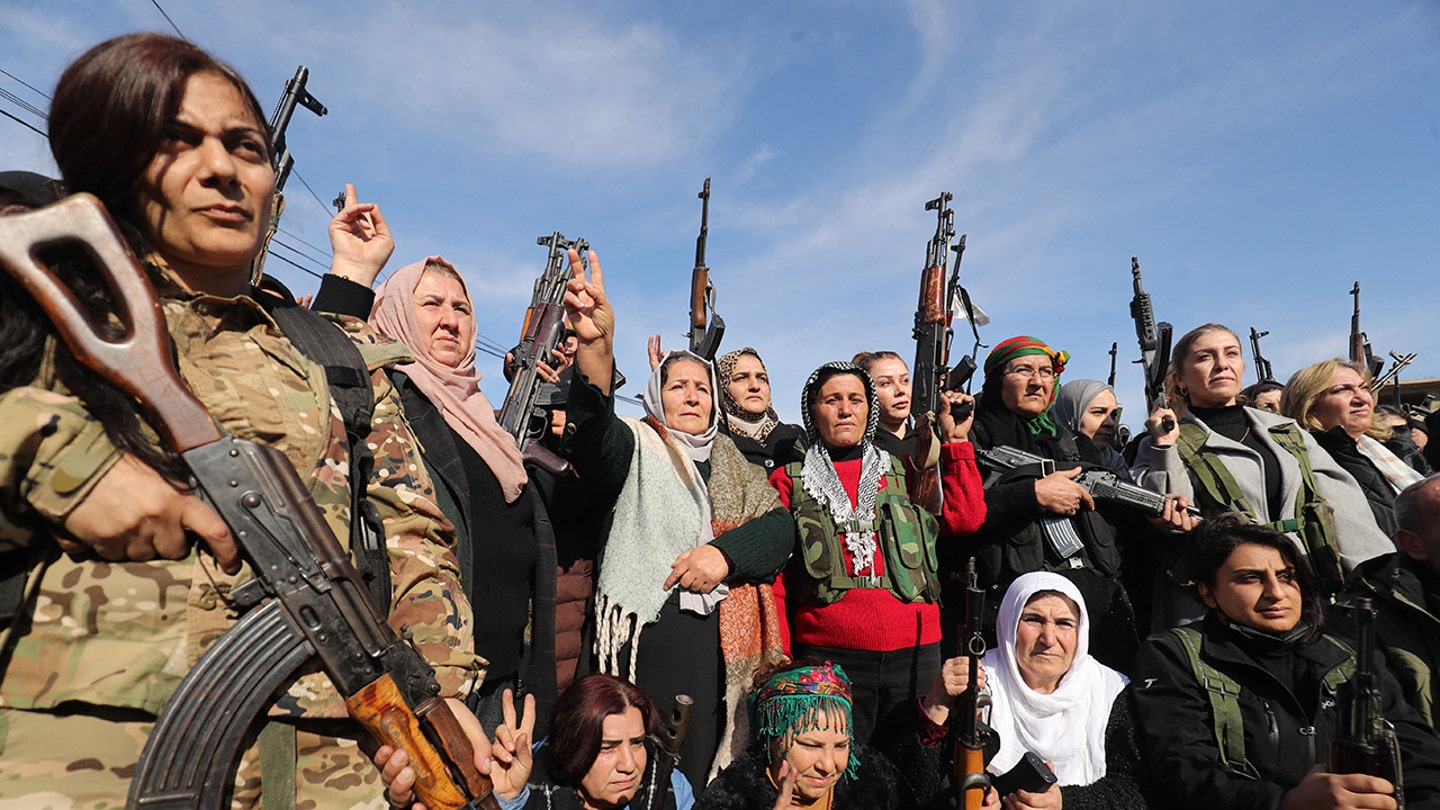Kurdish civilians gather with their weapons in the city of Qamishli on Jan. 20, 2026, after the Kurdish-led Syrian Democratic Forces called for "young Kurds, men and women" both within and outside Syria to "join the ranks of the resistance."