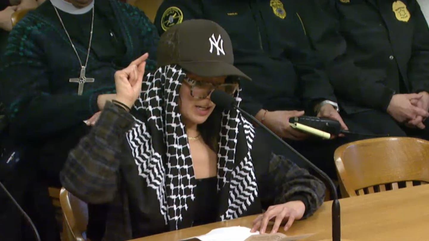 Milwaukee resident protests against Sheriff Jeffrey Norman at a Fire and Police Commission meeting.