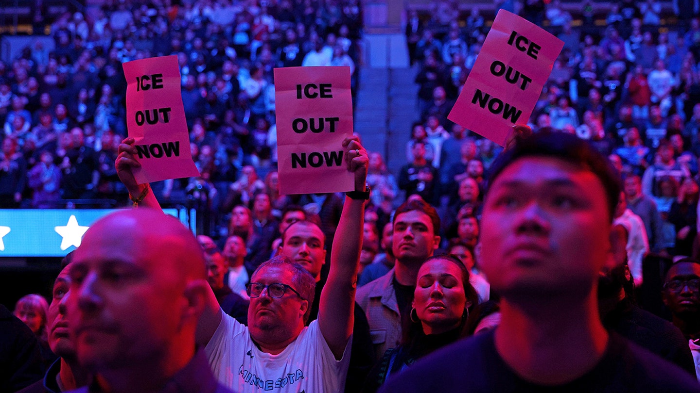 Fans hold signs to protest the presence of federal agents in Minneapolis prior to the start of an NBA game between the Golden State Warriors and Minnesota Timberwolves at Target Center on Jan. 25, 2026 in Minneapolis, Minnesota.