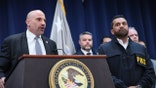 Christopher Raia stands next to FBI Director Kash Patel