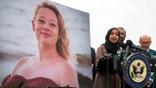 Ilhan Omar next to a poster of Renee Nicole Good