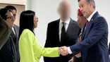Delcy Rodriguez shakes John Ratcliffe's hand