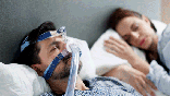 Man with sleep apnea wearing CPAP machine