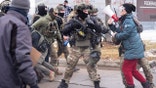 Person with megaphone confronts law enforcement in Minneapolis