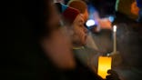 People hold candles during a candlelight vigil in Minneapolis, Minnesota, on January 28, 2026.