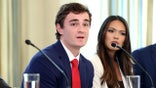 Independent journalist Nick Shirley speaks while seated at a table during a discussion inside the White House.
