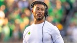 Notre Dame head football coach Marcus Freeman adjusting his radio on the sideline at Notre Dame Stadium