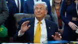 President Donald Trump sits in the Oval office at the White House