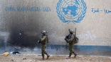 Israeli soldiers standing inside an evacuated UNRWA compound in Gaza City