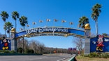 Walt Disney World entrance arch gate with Mickey and Minnie Mouse in Orlando Florida