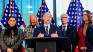 Chris Coons cruised past a challenger who legally changed his name to E. No-Trump Hansen, a candidate focused on curbing presidential power.