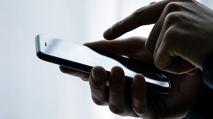 A person using their iPhone.