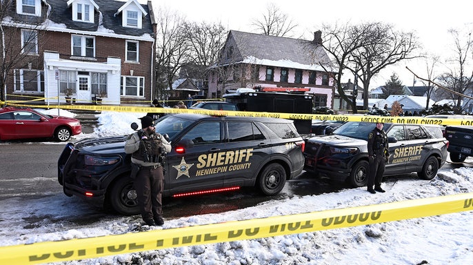 Police gather outside the scene of a suspected shooting by an ICE agent
