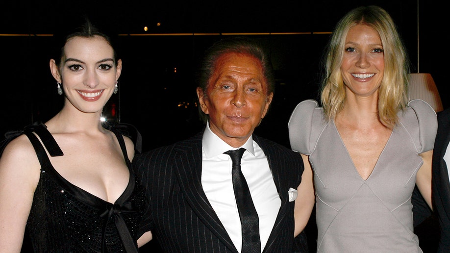 Anne Hathaway, Valentino Garavani and Gwyneth Paltrow pose while attending the Los Angeles premiere of 