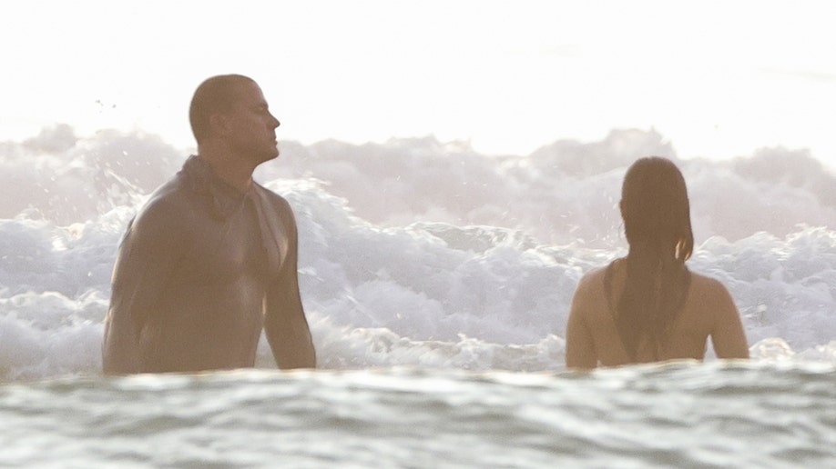 Tatum and Williams looking out at the ocean as they take a dip.