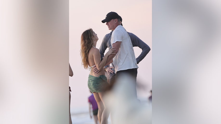 Tatum had his arms wrapped around Williams' waist as they embraced on shore.