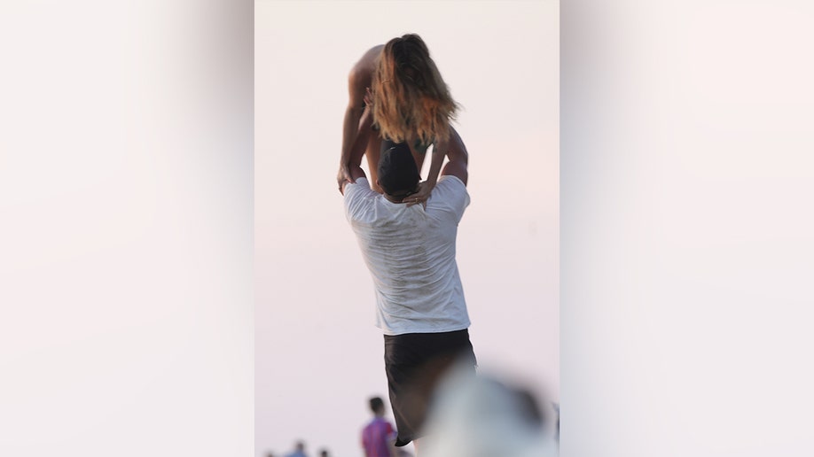 Channing Tatum held his girlfriend above his head in one of the photos.
