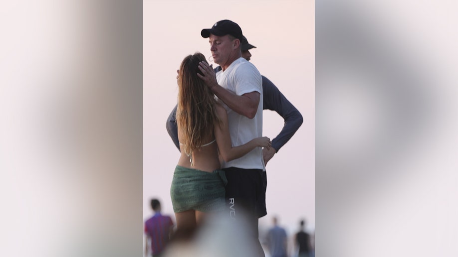 Channing Tatum and his girlfriend embracing on the sand in Costa Rica.