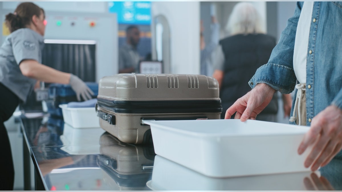Tourists Putting Personal Items and Baggage for X-ray Scanning, Then Walking Through Metal Detector Scanner. TSA Worker Controlling Screening Procedure.
