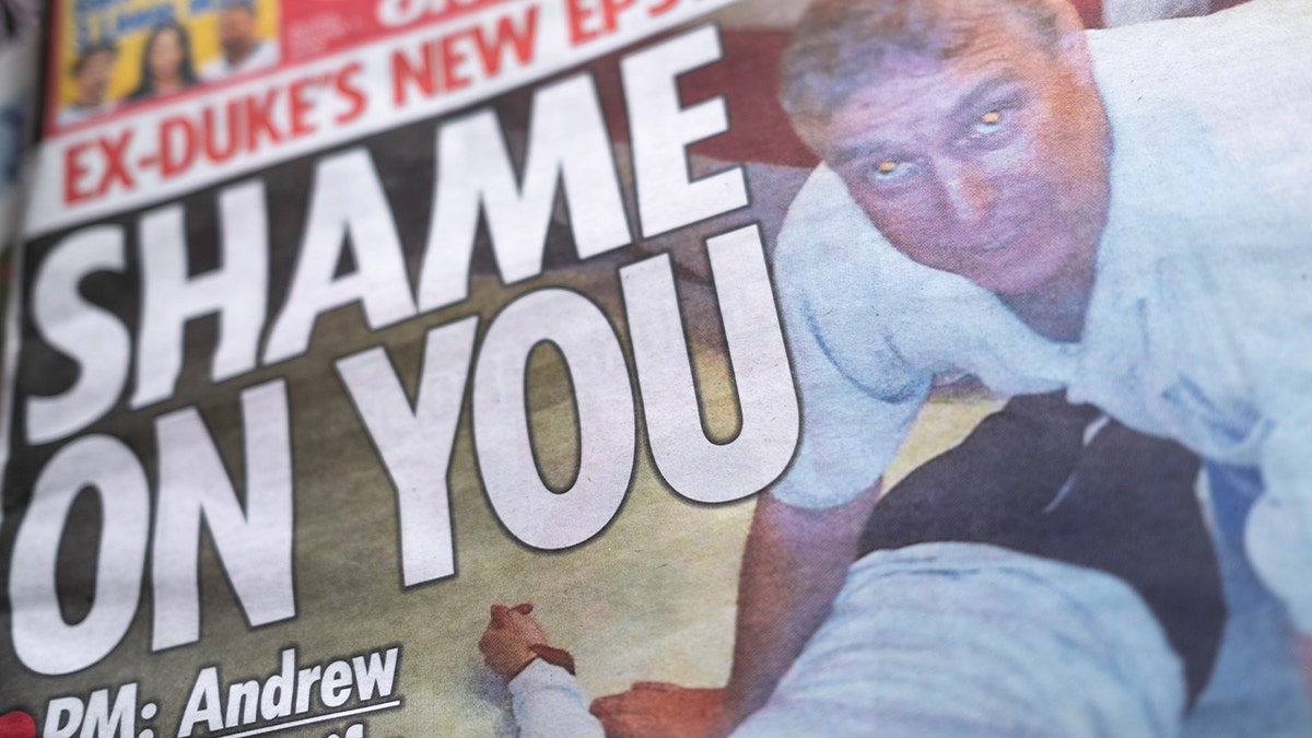 newspaper depicting photo of Andrew Mountbatten-Windsor on top of girl