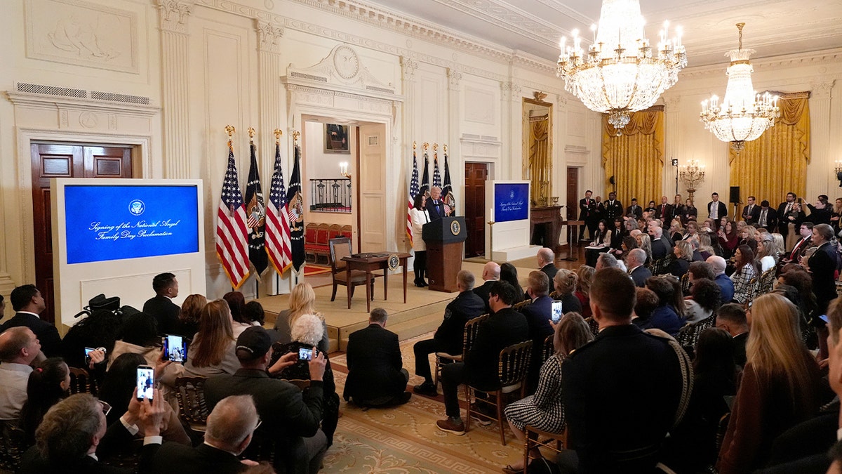 Familes gather in the East Room of the White House.