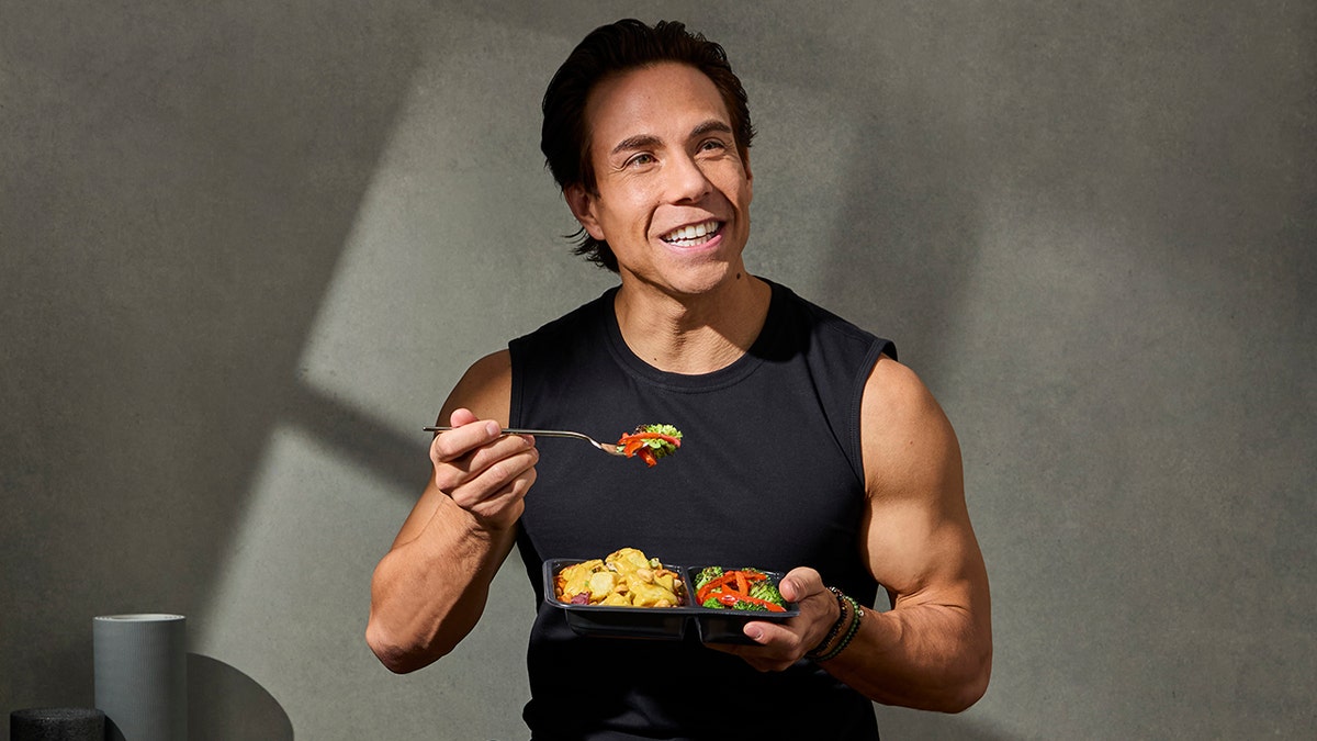 Former Olympian speed skater Apolo Ohno eating healthy Factor meal prep dish.
