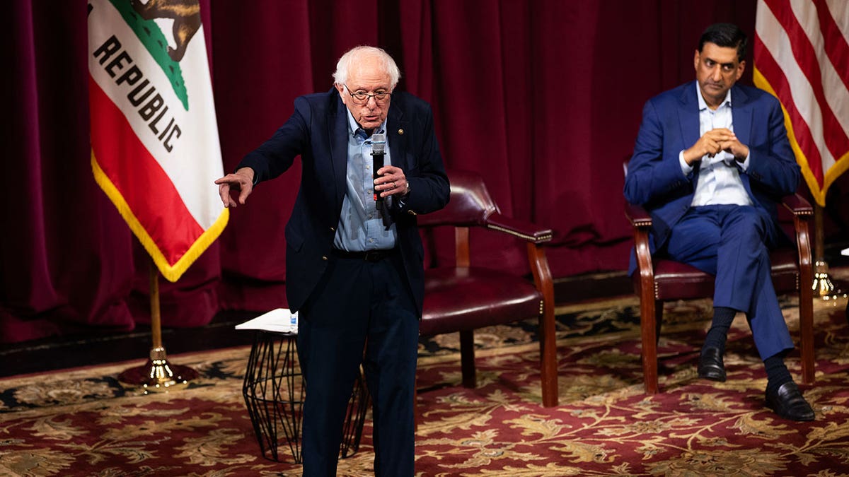Sen. Bernie Sanders (I-VT) speaks next to Rep. Ro Khanna (D-CA) at a town hall event on February 20, 2026 in Stanford, California. The town hall focused on taxing billionaires and the future of AI. (Photo by Benjamin Fanjoy/Getty Images)