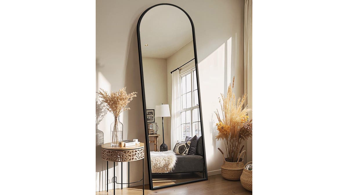 A full-length mirror reflects light and makes your space feel bigger.