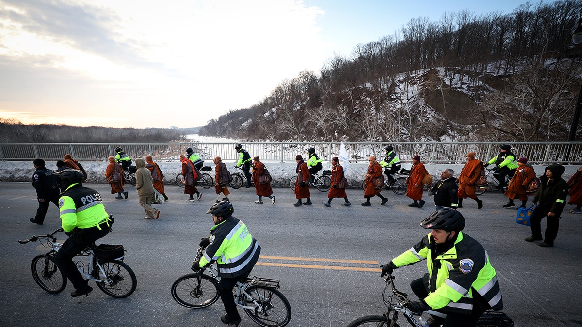 Buddhist monks cross from Virginia to Washington, D.C. using the Chain Bridge