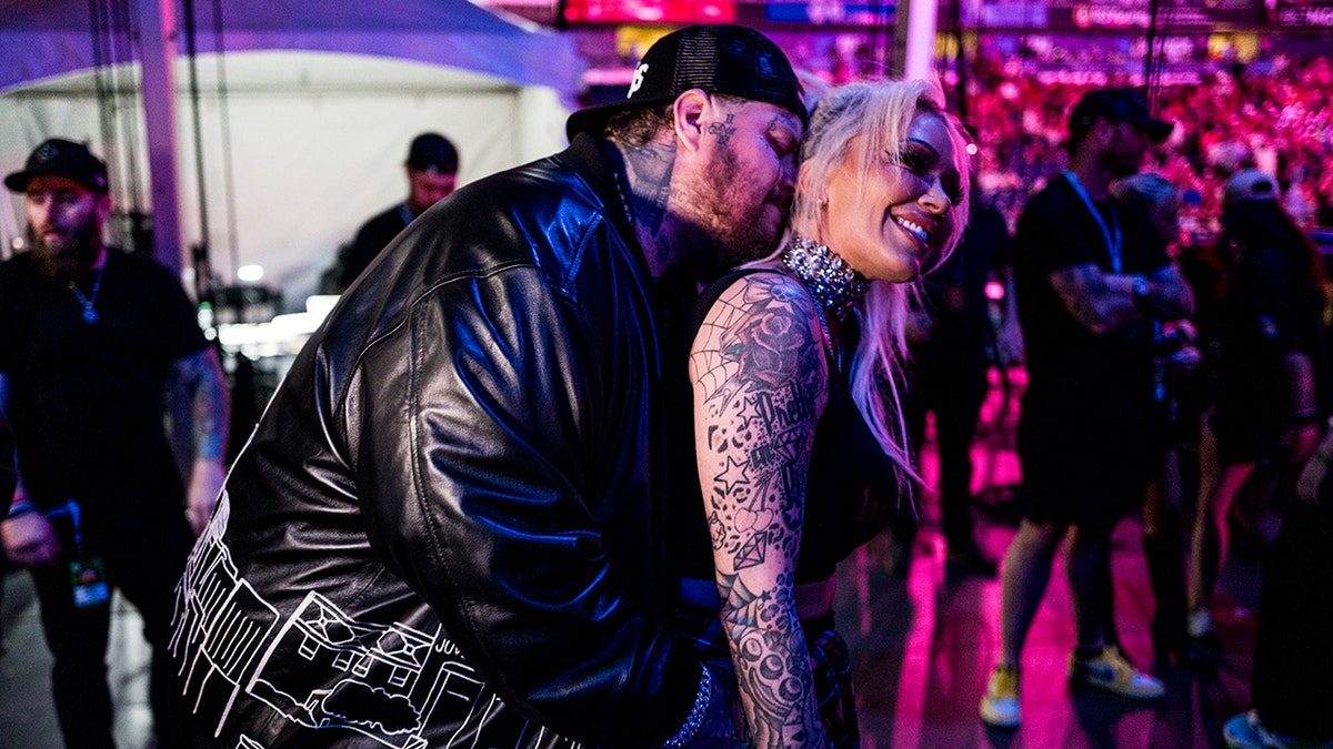 Jelly Roll embracing his wife Bunnie Xo at CMA Fest.