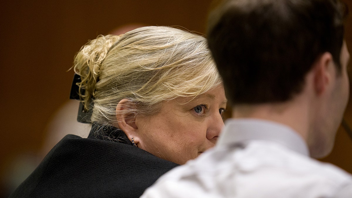 Kathryn Nester during a hearing in a courtroom.